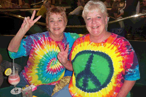 Fans in Tie Dye Shirts giving the Peace Sugn